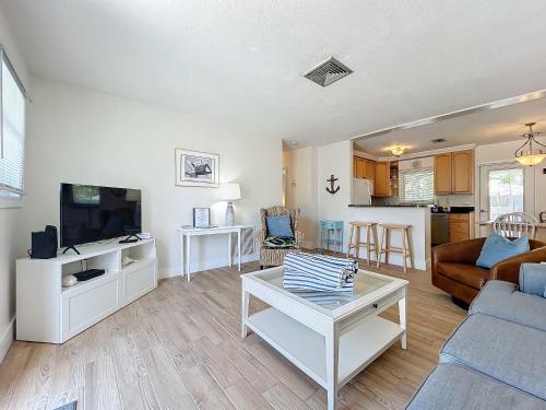 a living room with a couch and a tv at Blue Wave Villa East in Anna Maria