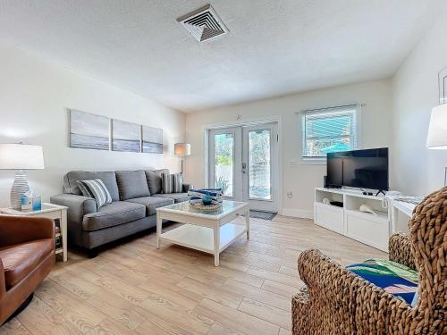 a living room with a couch and a tv at Blue Wave Villa East in Anna Maria