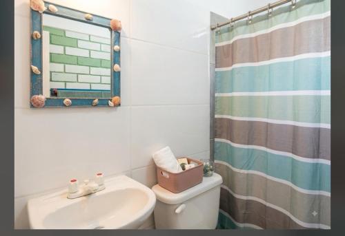 a bathroom with a sink and a toilet and a shower at CO Casa Ocean in Juan de Acosta
