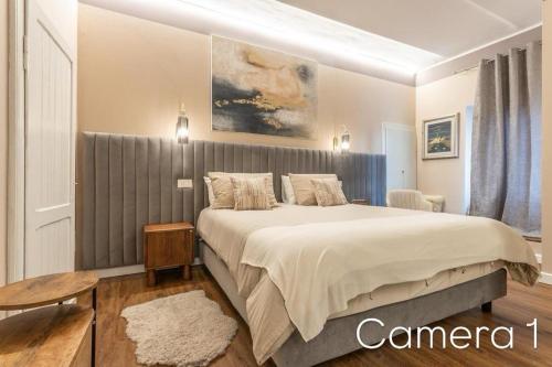 a bedroom with a large bed in a room at valter rooms 1 in Castel del Piano