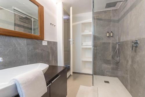a bathroom with a shower and a sink and a tub at valter rooms 1 in Castel del Piano
