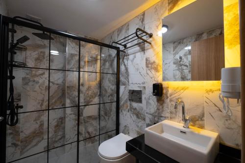 a bathroom with a sink and a shower and a toilet at HOPEFULL HOTEL in Istanbul