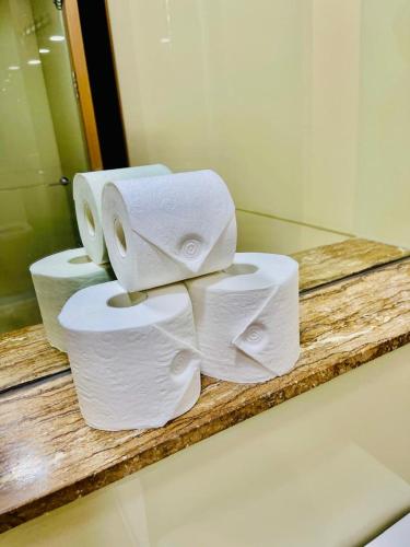 a pile of toilet paper on a counter in a bathroom at Soho Suites KLCC by Minsha in Kuala Lumpur