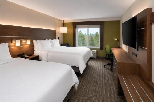 a hotel room with two beds and a flat screen tv at Holiday Inn Express & Suites Halifax Airport by IHG in Enfield