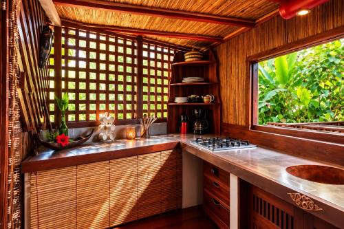 a kitchen with a sink and a window at Analatsara Eco Lodge in Ile aux Nattes