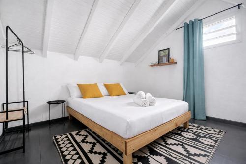 a bedroom with a bed with two towels on it at Private Villa, Castel in Lamentin