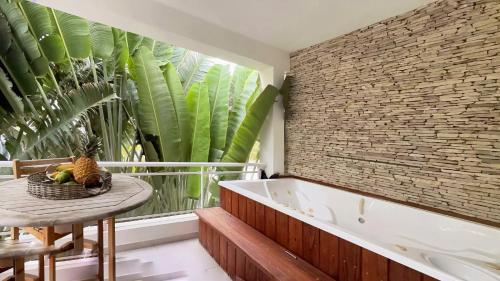 a bathroom with a tub and a table with a basket of fruit at Elegant 2 Bedroom Apartment with Pool in La Laguna