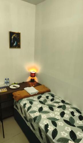 a bedroom with a bed and a table with a lamp at Dream International City Homes in Dubai