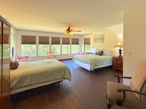 a bedroom with two beds and a ceiling fan at Hidden Oasis Near Downtown in Eureka Springs