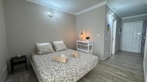 a bedroom with a bed and a table and a door at Green Park ApartHotel Tenerife in San Miguel de Abona