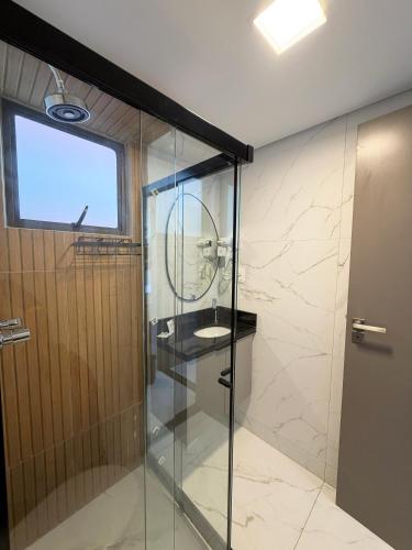 a bathroom with a shower with a sink and a mirror at Smeralda del Mare by AFT in Porto De Galinhas