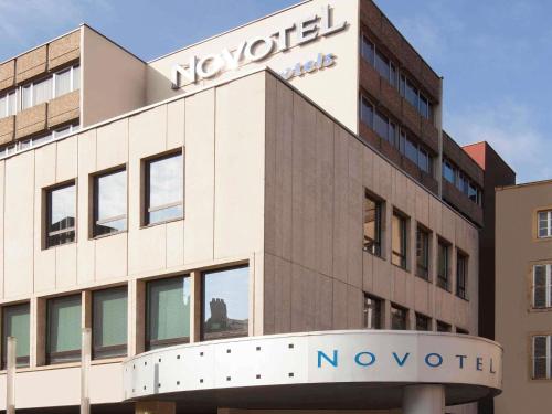 a building with a sign on top of it at Novotel Metz Centre in Metz