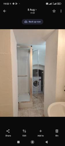 a picture of a bathroom with a refrigerator at Brasov Sfat Apartament in Braşov