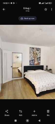 a picture of a bedroom with a bed and a mirror at Brasov Sfat Apartament in Braşov
