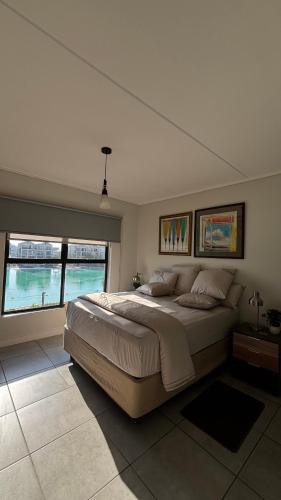 a bedroom with a large bed and two windows at Waterfall Apartments Waterfall Cres in Midrand