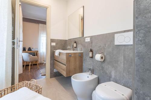 a bathroom with a white toilet and a sink at valter rooms 2 in Castel del Piano
