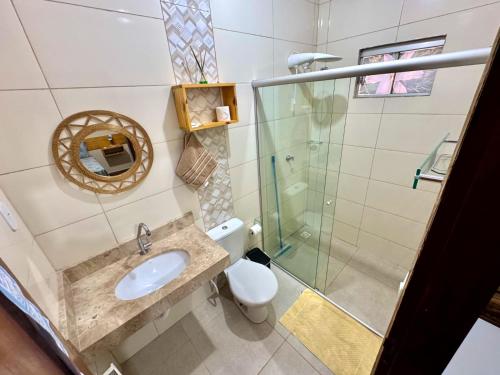 a bathroom with a sink and a shower at Pousada Canela de Ema in Mateiros