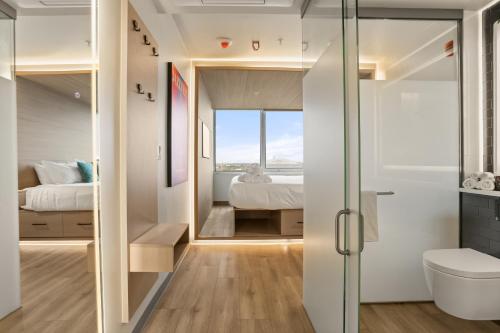 a bathroom with a glass door leading to a bedroom at VCAY Hotel 5BR 5BA Group Suite Near Superdome in New Orleans