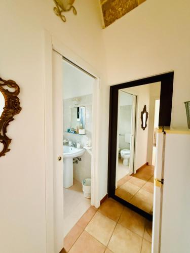a bathroom with a mirror and a sink at B&B NONNA TINA in Gemini