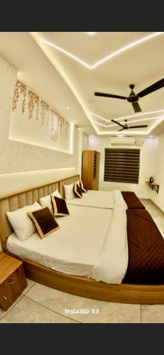 a bedroom with a large bed with pillows on it at Palazhi Inn in Trivandrum