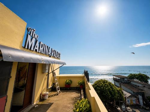 a building with a sign that reads the miamianking make at The Marina Palace Calicut Premium Beach Hotel in Kozhikode