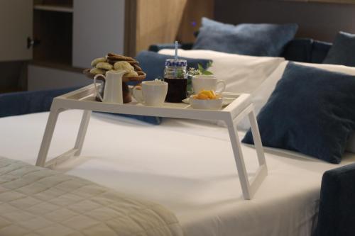 a tray of food on top of a bed at Bed & Breakfast Oasi San Giovanni in Altamura