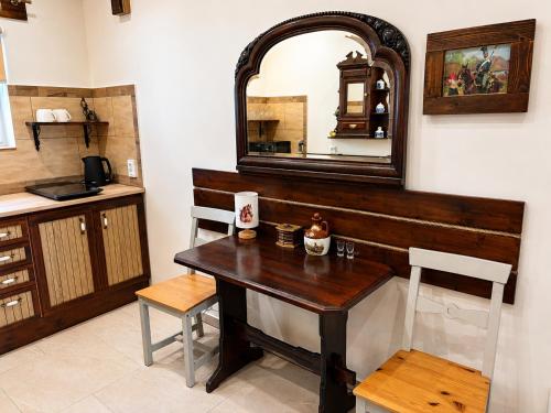 a kitchen with a wooden table and a mirror at Pokój dyrektora stadniny in Niezgoda