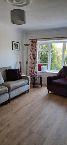 a living room with a couch and a window at Willow Cottage 3 bed, cosy stopover, dogs welcome in Thornton-le-Beans