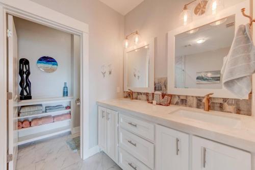 a bathroom with two sinks and a mirror at Beach Life in Port Aransas