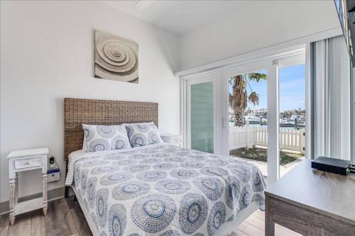 a bedroom with a bed and a view of the ocean at Port A Del Rey in Port Aransas