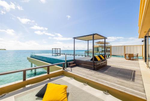 a boat deck with a gazebo on the water at Angsana Velavaru - part of Banyan Group with Free return Seaplane Transfers in Dhaalu Atoll