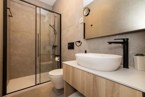 a bathroom with a sink and a toilet and a shower at Andrea Deluxe Apartment with Pool in Mali Lošinj