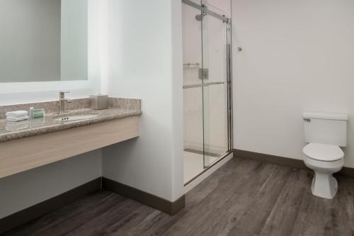 a bathroom with a toilet and a glass shower at TownePlace Suites by Marriott San Pablo in San Pablo