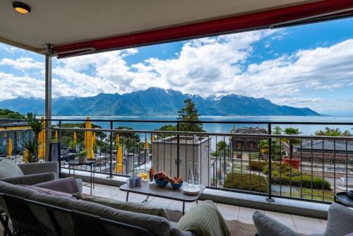 a balcony with a view of the water and mountains at Spacious 3BR Lakeview Apartment with Terrace by GuestLee in Montreux