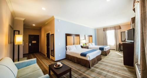a hotel room with two beds and a couch at Holiday Inn Express Benicia by IHG in Benicia