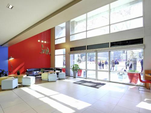 a lobby with a large room with a large window at ibis Buenos Aires Congreso in Buenos Aires