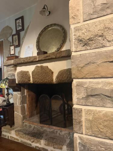 a stone fireplace with a plate on top of it at Casale Santilli in Agnone
