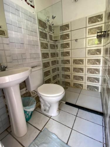 a bathroom with a toilet and a sink at Pico das Praias Suites in Itacaré