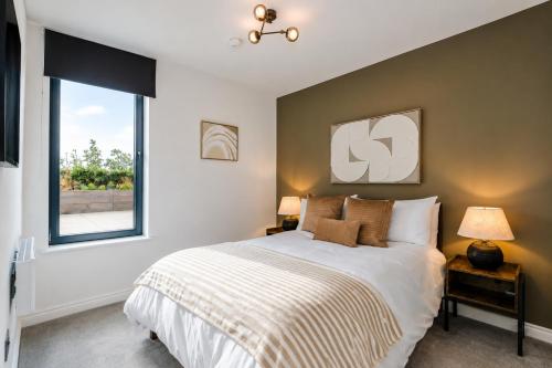 a bedroom with a large bed and a window at City Penthouse - Roof Terrace & Free Parking in Beeston Hill