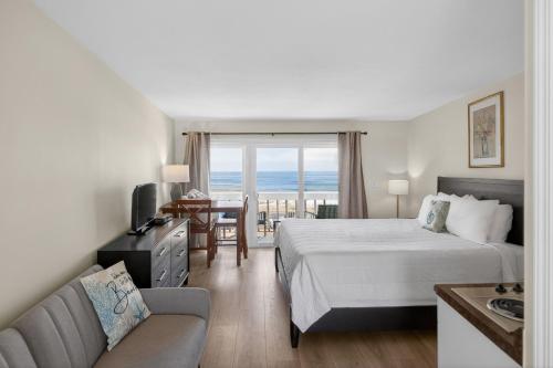a hotel room with a bed and a couch at Ocean Surf Resort in Montauk