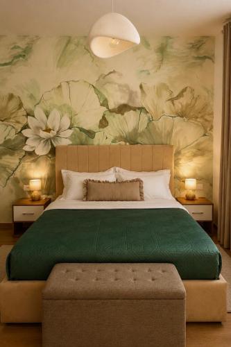 a bedroom with a large bed with a flower wallpaper at Green Hill Villa in Tirana