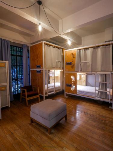 a room with two bunk beds and a chair at Casa Pepe in Mexico City