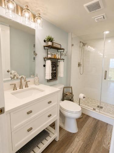 a bathroom with a sink and a toilet and a shower at Ocean Pointe Resorts - Serenity 2308 in Tavernier