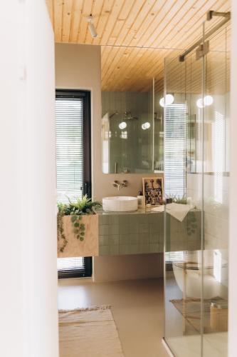 a bathroom with a sink and a mirror at Projekt Babia - Domek z jacuzzi in Lipnica Wielka