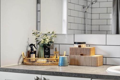 a bathroom counter with a basket of items on it at 1005-Thisted-Spanggardsvej-39 in Torsted