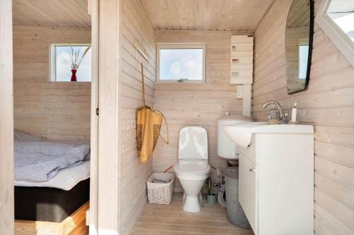 a small bathroom with a toilet and a sink at 1355-Vestervig-Klitvej-4 in Agger