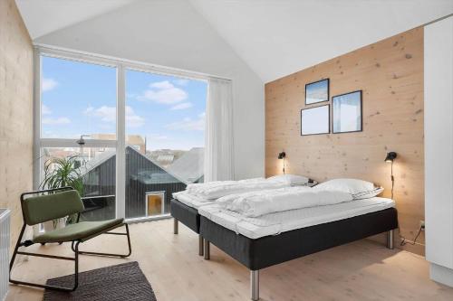 a bedroom with a bed and a large window at 7726-Hvide-Sande-Slusen-26 in Hvide Sande