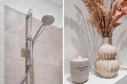 a shower head and a vase with a candle at 782-Hvide-Sande-Norregade-2-nr-25 in Hvide Sande