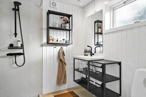 a bathroom with a sink and a shower at 7032-Bogo-Kvaernen-32 in Gammelby