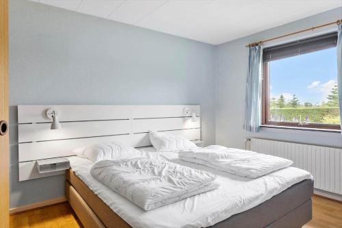 a bedroom with a large white bed with a large window at 4035-Borre-Bogebjergvej-15 in Borre
